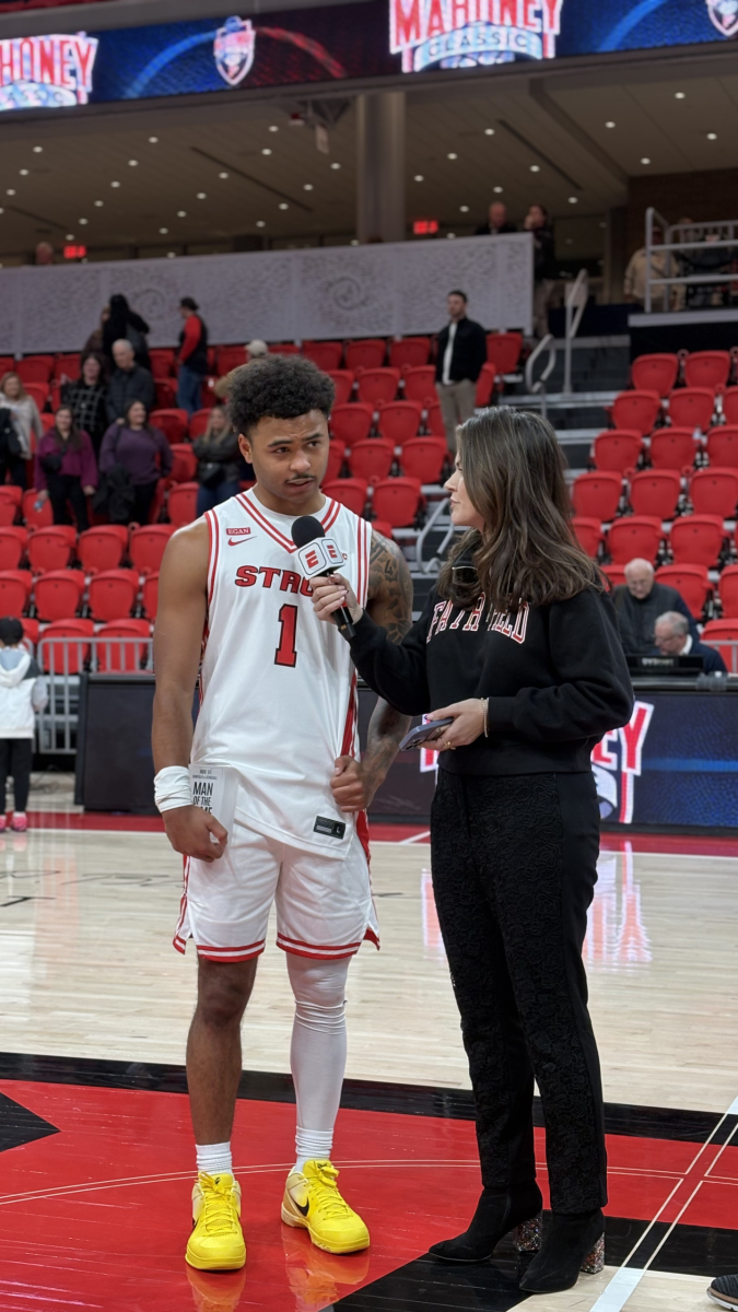 Deuce Turner talks with In-Arena host Casey DelBasso after the Stags' win over Stonehill at Mahoney Arena in Fairfield, Conn., Friday, Nov. 14, 2025.